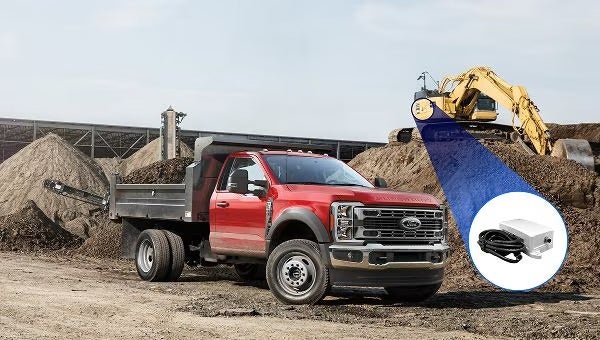 Red dump truck at worksite with equipment tracker highlighting excavator.