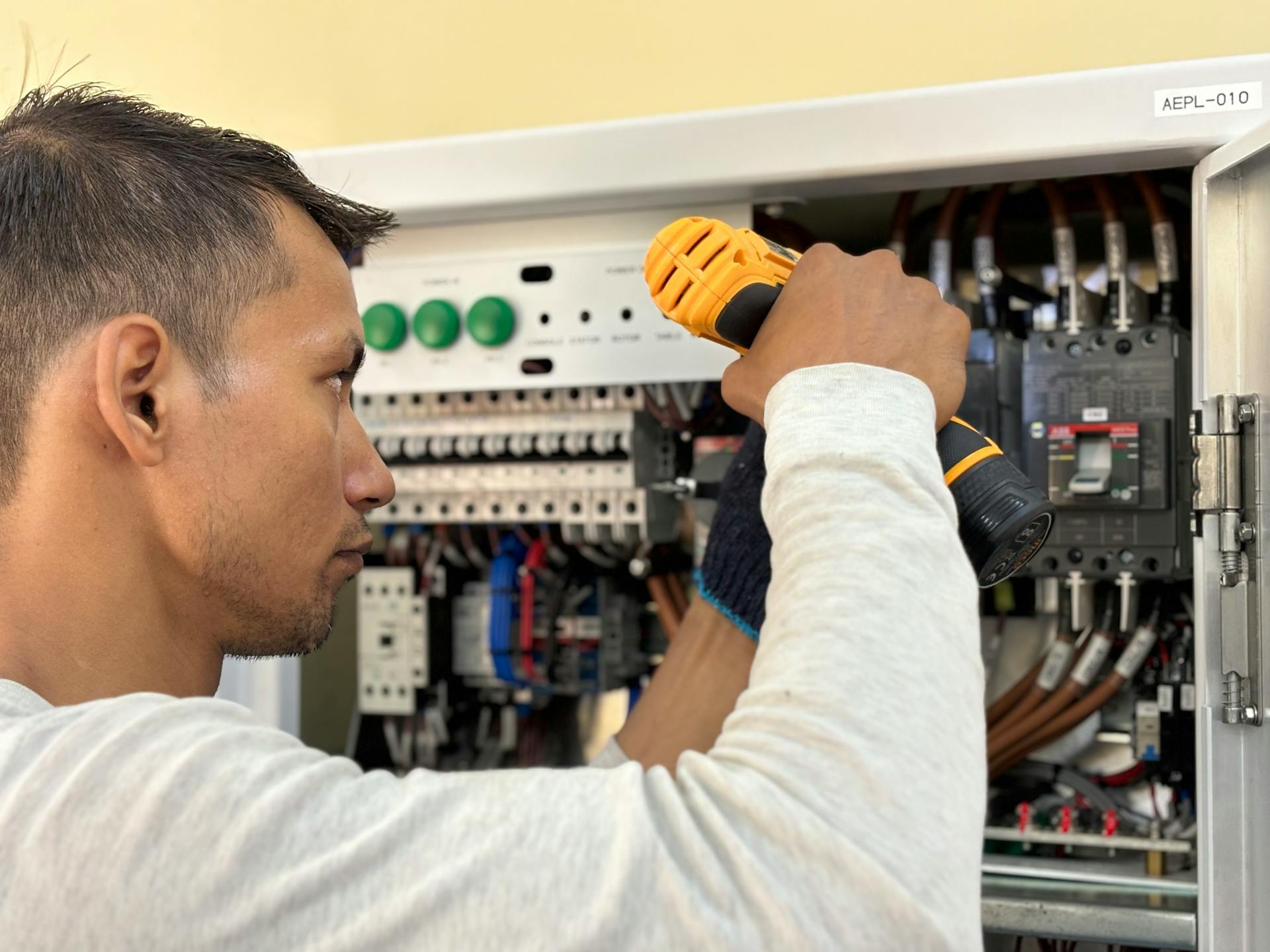 An electrician working on a panel